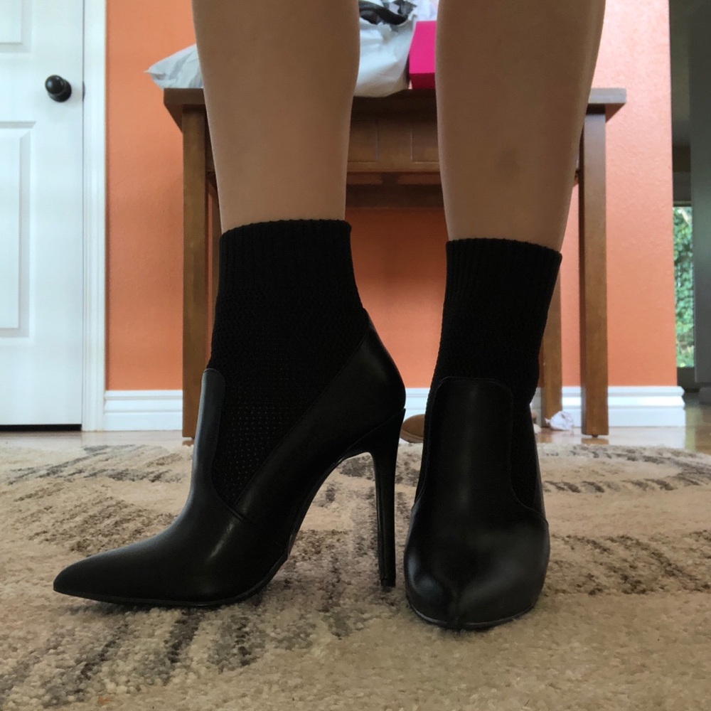 Black stiletto heeled sock bootie.